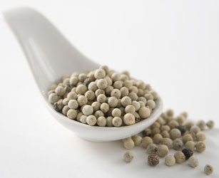 Close-up of whole white peppercorns — smooth, clean heat for white sauces and Asian cooking
